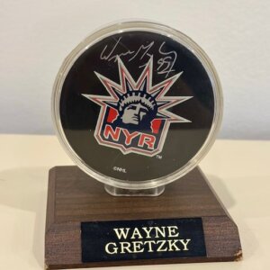 Wayne Gretzky autographed official NHL puck with Beckett COA displayed in protective case.