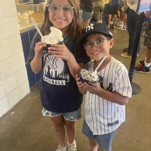 NY Yankee Fans at the stadium eating ice cream