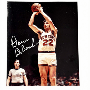 Dave DeBusschere shooting a jump shot in a signed New York Knicks photo with COA.