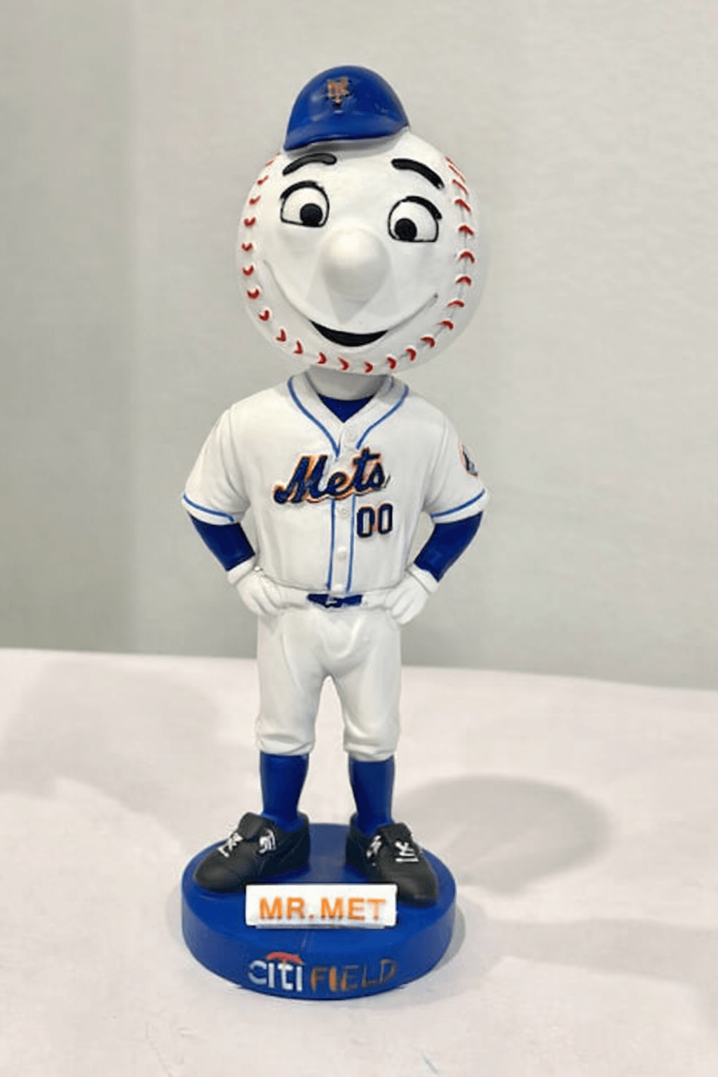 Mr. Met bobblehead figurine wearing a Mets uniform, standing on a blue base labeled Citi Field.