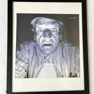 Casey Stengel looking into a crystal baseball in classic Yankees photo