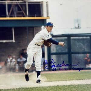Bud Harrelson throwing a baseball in Mets uniform, signed photo with ’69 W.S. Champs inscription.