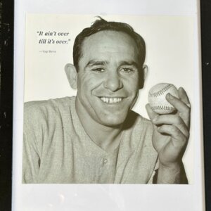 Framed photo of Yogi Berra smiling with his quote "it ain't over till its over