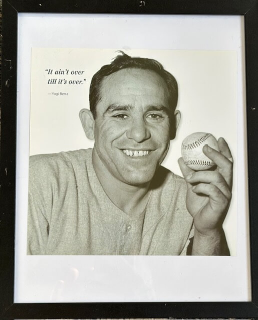 Framed photo of Yogi Berra smiling with his quote "it ain't over till its over