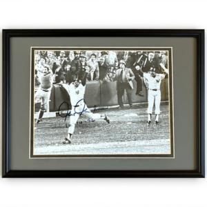 Chris Chambliss running to first with arms extended after 1976 walk‑off home run, with Thurman Munson and Roy White jumping in celebration behind him, signed with 10‑14‑76.