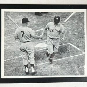 Roger Maris hitting a home run as Mickey Mantle watches in a classic Yankees scene